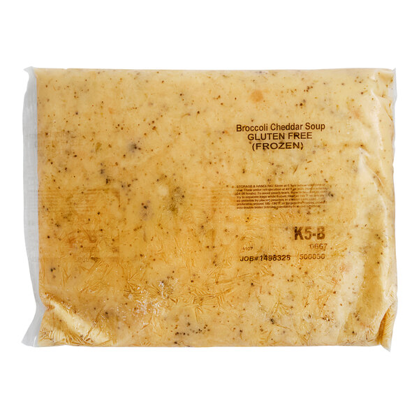 A plastic bag of Kettle Cuisine Cheddar Broccoli Soup on a white background.