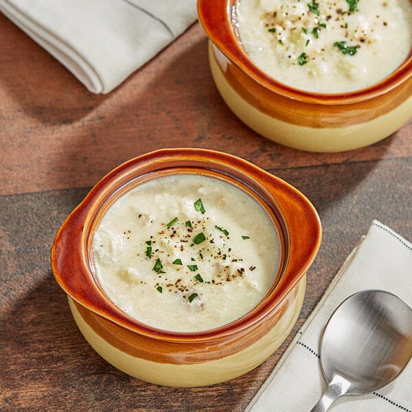Two bowls of Blount Fine Foods New England Clam Chowder with spoons on a napkin.