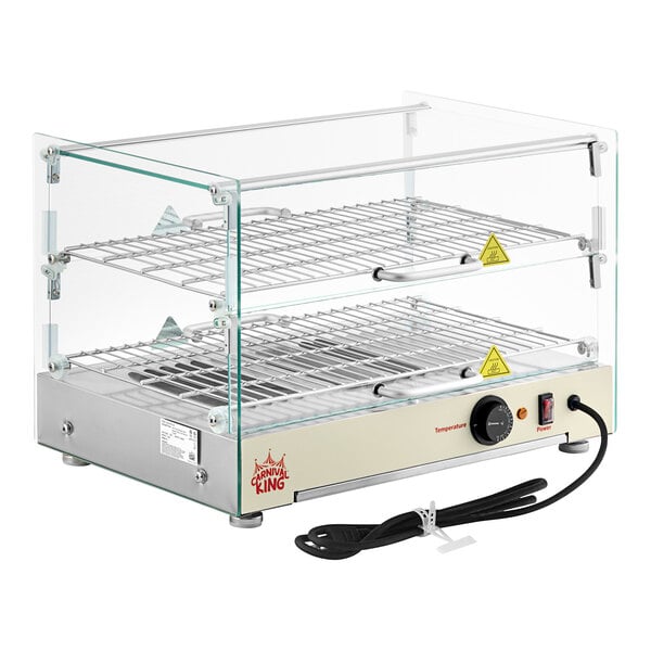 A Carnival King silver glass countertop food warmer with metal racks inside.