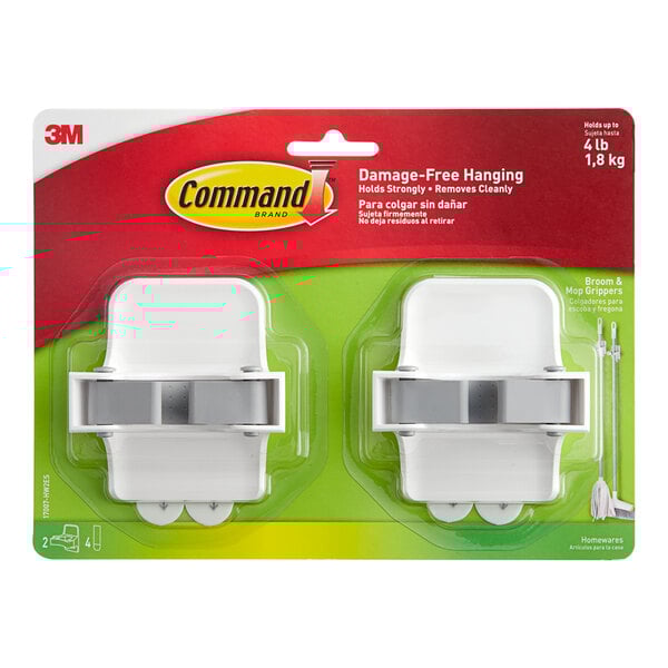 A package of 2 white plastic 3M Command Broom Grippers with grey parts.