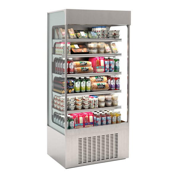 A Hussmann stainless steel vertical air curtain merchandiser with food and beverages on shelves.