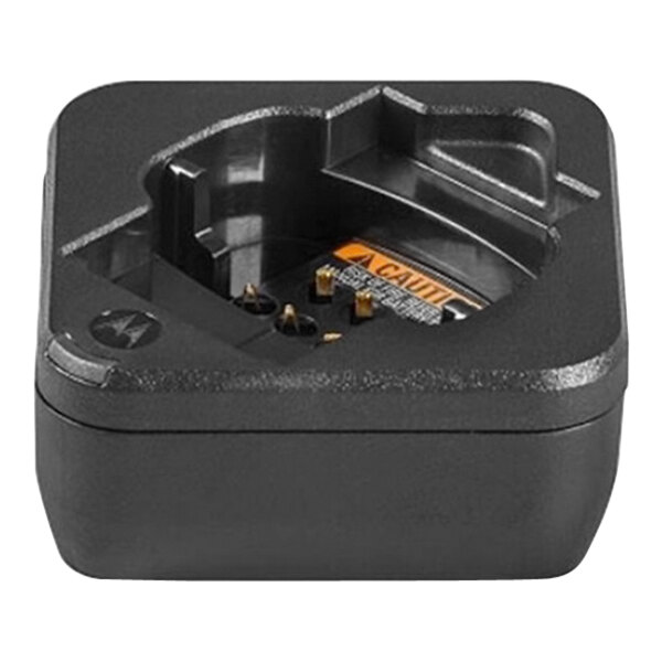 A black plastic Motorola battery charger with a yellow label and an orange plug.