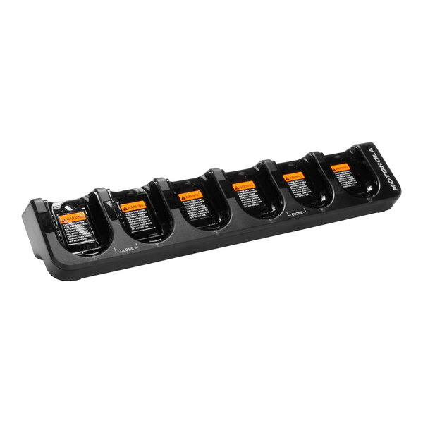 A black Motorola 6-unit battery charger with orange labels.