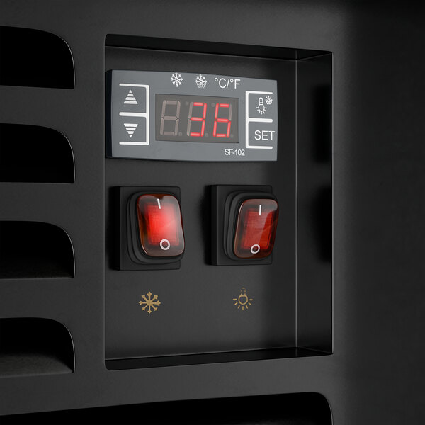 A control panel of a black refrigerated air curtain merchandiser with a digital display and two red switches.
