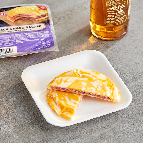 A close-up of a Cheesewich Salami and Colby Jack Cheese sandwich on a plate.
