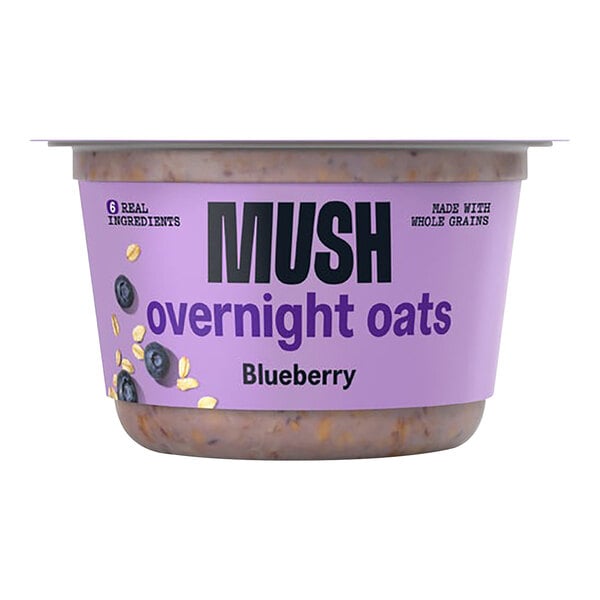 A case of MUSH Blueberry Overnight Oats on a table with a purple label.