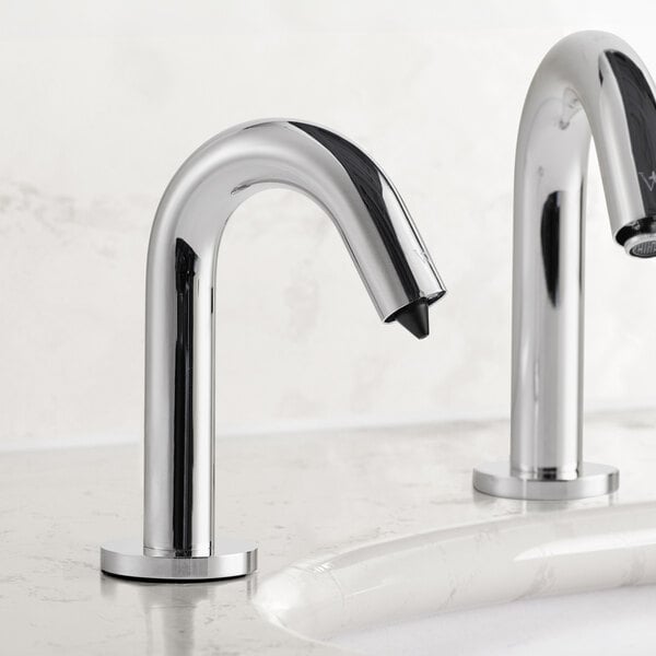A close-up of a Waterloo chrome automatic soap dispenser on a white counter.