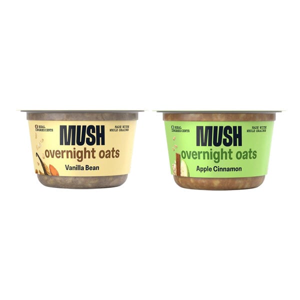 Two containers of MUSH Vanilla Bean and Apple Cinnamon Overnight Oats with labels.