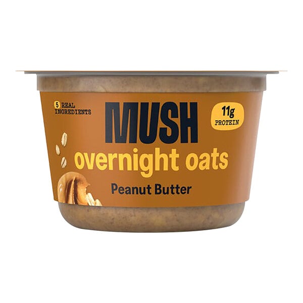 A case of MUSH Peanut Butter Overnight Oats on a table with a yellow and brown label.