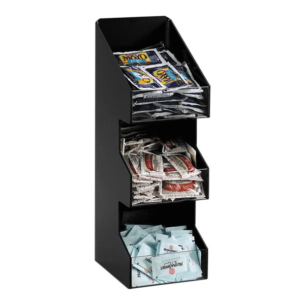 A black Dispense-Rite countertop organizer with packets in it.