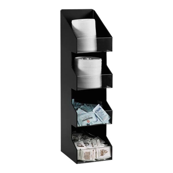 A black Dispense-Rite countertop organizer with 4 sections holding various items.