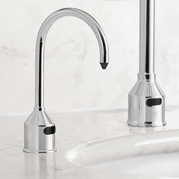 A Waterloo tall chrome automatic soap dispenser with foam spout on a white counter.