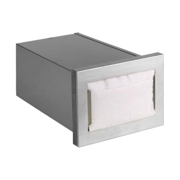 A stainless steel Dispense-Rite napkin holder on a counter with white napkins inside.