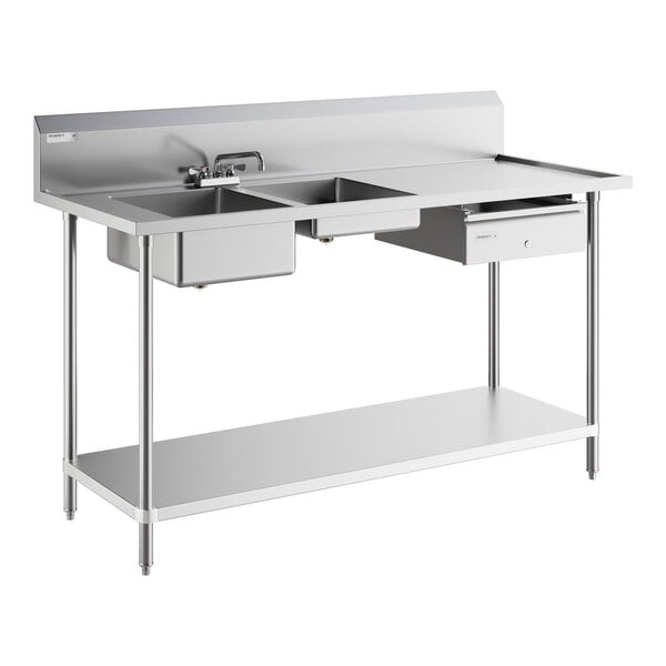 A Regency stainless steel work table with two sinks on the left.