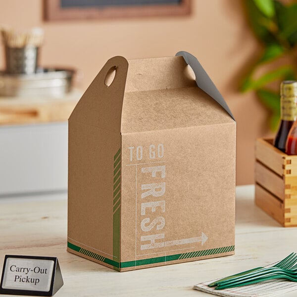 A brown cardboard barn lunch box with a fresh print design on a table.