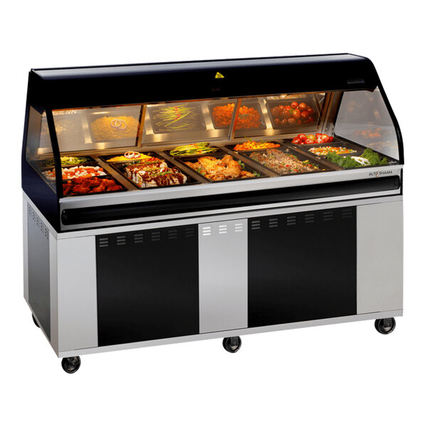 An Alto-Shaam black heated food display case on a counter with food trays inside.