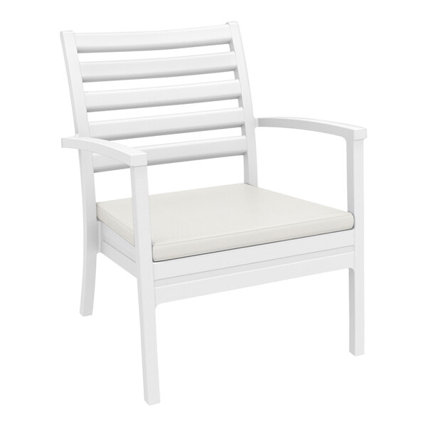 A Siesta Artemis XL white outdoor club arm chair with a Sunbrella natural cushion.