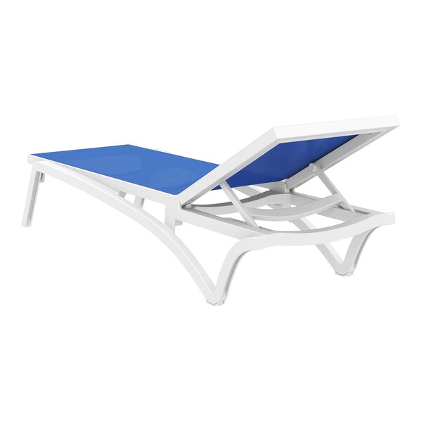 A Siesta Pacific white resin chaise lounge chair with blue sling.
