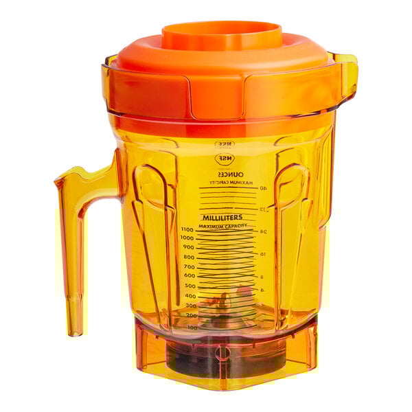 An orange Vitamix blender jar with a lid on top.
