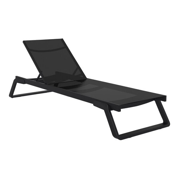A Siesta Tropic black resin outdoor chaise lounge with black sling on a white background.