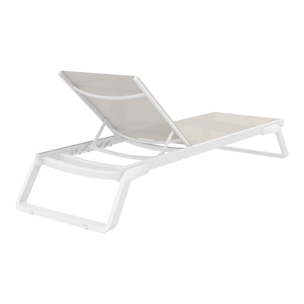 A Siesta Tropic white resin outdoor chaise lounge with a taupe sling on a white background.