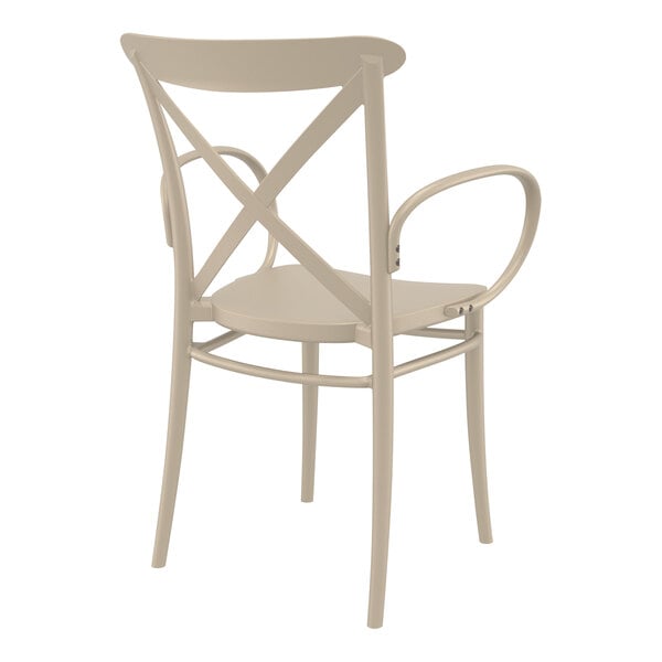 A taupe resin outdoor dining arm chair with a cross back.