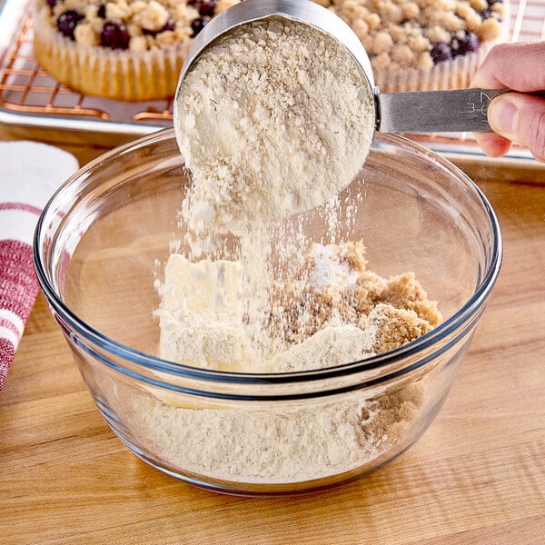 A person pouring Cargill Prolia soy flour into a bowl.