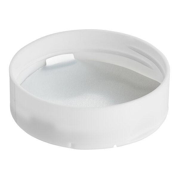 A white round plastic spice container with a white dual flapper lid with 7 holes.