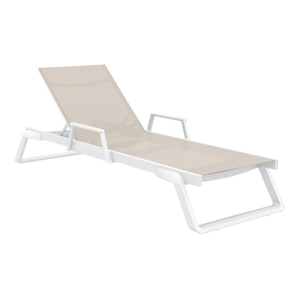 A Siesta Tropic white resin outdoor chaise lounge chair with taupe armrests.