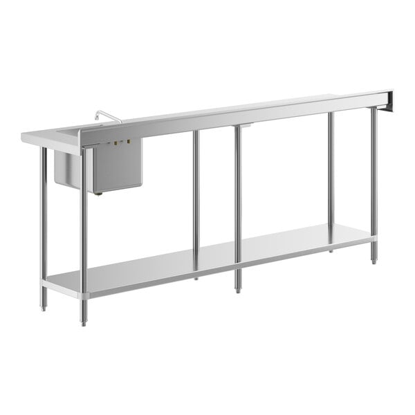 A long stainless steel work table with an integrated sink and faucet on the right side.