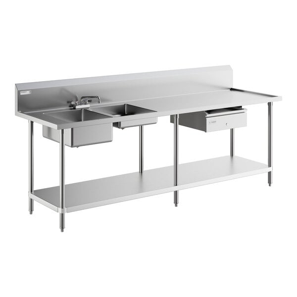 A Regency stainless steel work table with 2 sinks on a counter.