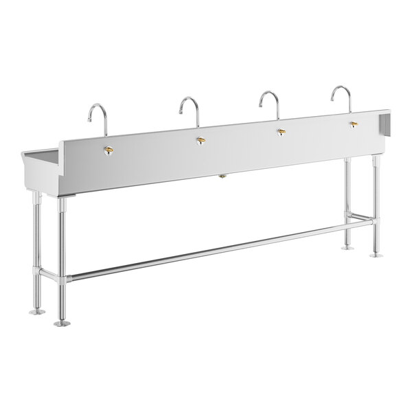 The back of a stainless steel Regency hand sink with four faucets.