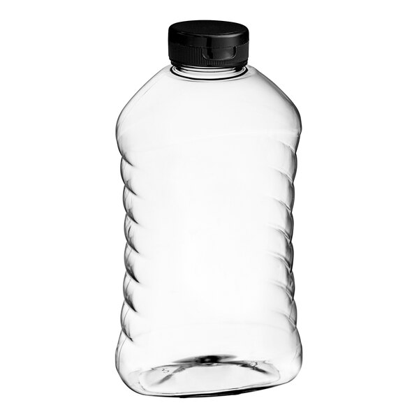 A clear plastic ribbed hourglass honey bottle with a black plastic flip top lid.