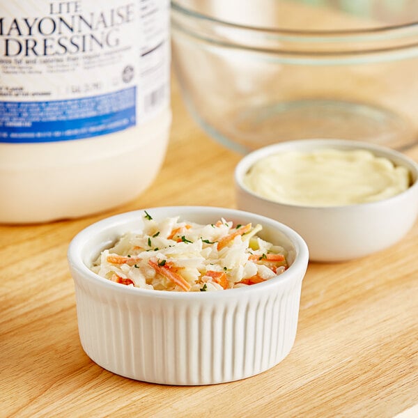 A bowl of coleslaw with Ken's Foods Lite Mayonnaise in the background.