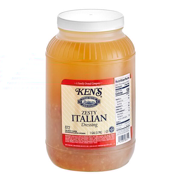 A plastic container of Ken's Zesty Italian Dressing.
