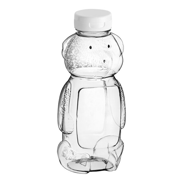 A clear plastic Bear PET honey bottle with a white plastic flip top lid.