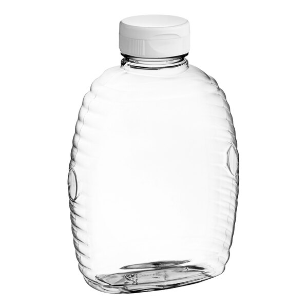 A clear plastic Queenline honey bottle with a white flip top lid.