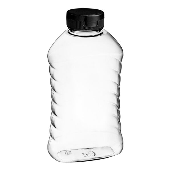 A clear ribbed plastic honey bottle with a black flip top lid.