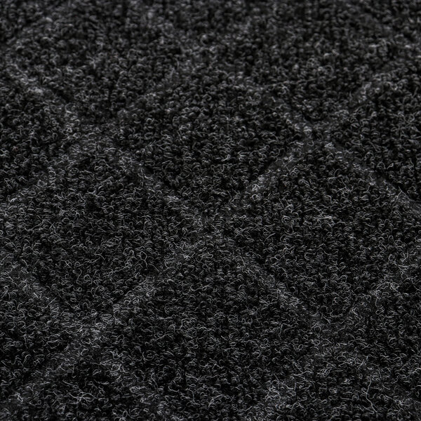 A close-up of a black CleanShield universal mat with squares.