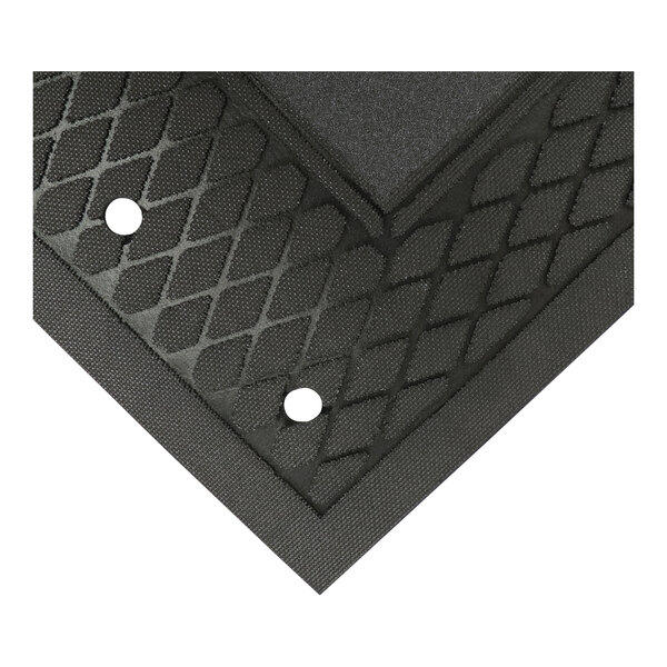A close up of a black rubber Traction Tread Grit mat with holes in it.
