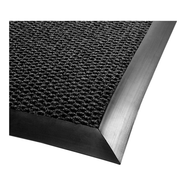 A black Berber carpet mat with vinyl and rubber border.