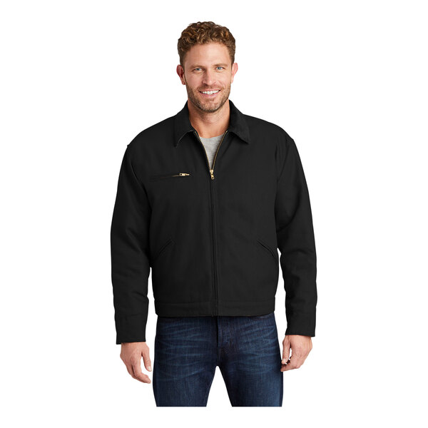 A man wearing a black CornerStone work jacket with a corduroy collar.