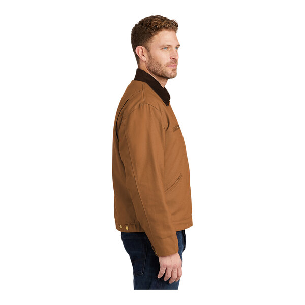 A man wearing a CornerStone brown work jacket with black corduroy collar.