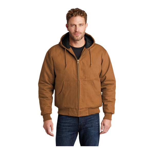 A man wearing a CornerStone brown duck cloth hooded work jacket.