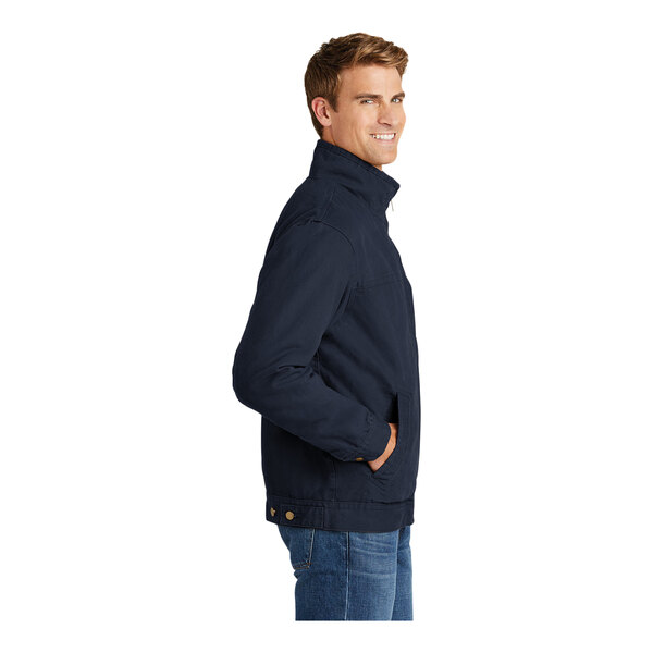 A person wearing a navy CornerStone flannel-lined work jacket with a zipper.