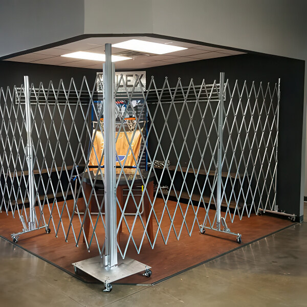 An Illinois Engineered Products heavy-duty galvanized steel portable folding access control gate in a room.