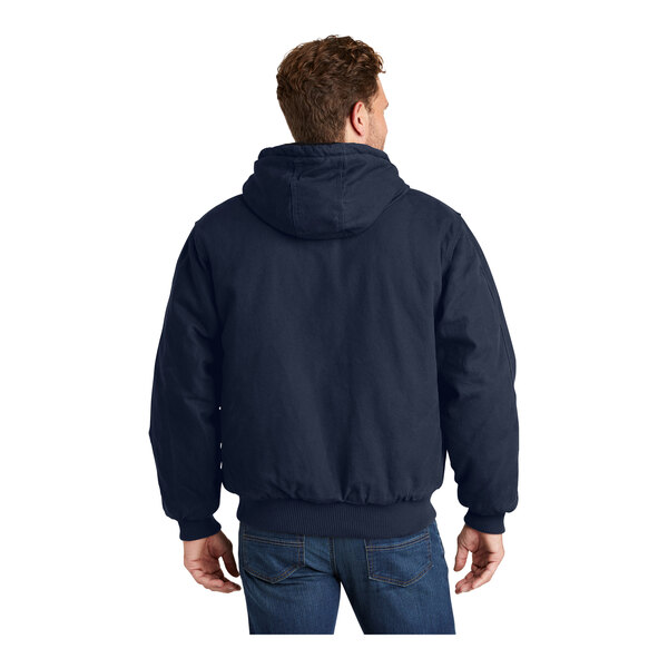 A man wearing a navy CornerStone insulated hooded work jacket.