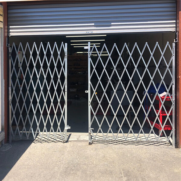 An Illinois Engineered Products heavy-duty galvanized steel folding double security gate installed in a garage.