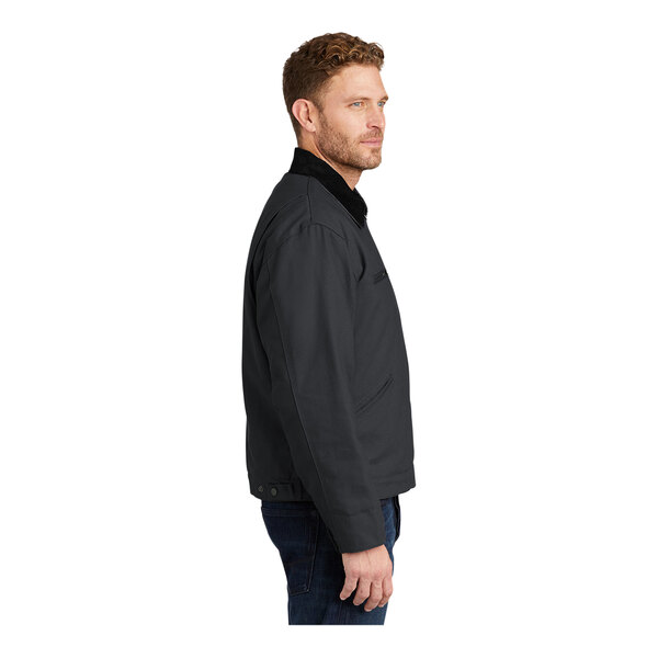 A man in a CornerStone charcoal work jacket with a black corduroy collar.