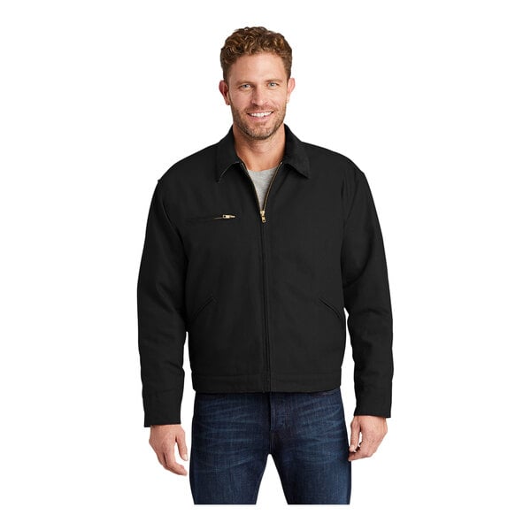 A man wearing a black CornerStone work jacket with a corduroy collar.
